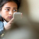 girl on phone cyberbullying